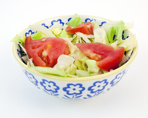 Simple salad-lettuce and tomatoes, in a bowl. Horizontal.
