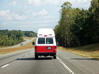 Para transit ambulance vehicle on highway. Horizontal.