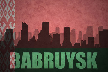 Fototapeta premium abstract silhouette of the city with text Babruysk at the vintage belarus flag