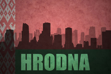 abstract silhouette of the city with text Hrodna at the vintage belarus flag