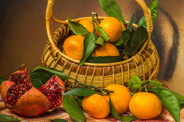 still life with fresh  tangerines  in a basket and grenades.