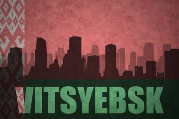 abstract silhouette of the city with text Vitsyebsk at the vintage belarus flag