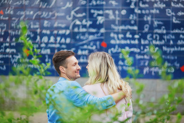 Couple near I love you wall on Montmartre