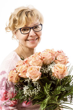 Beautiful, blond mature woman with bunch of roses