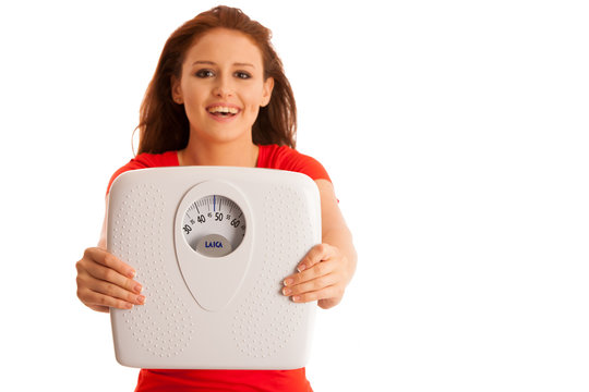 Woman with scale happy with her weight isolated over white backg