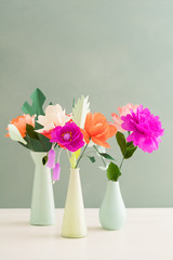 Bouquet of handmade paper flowers in different vases