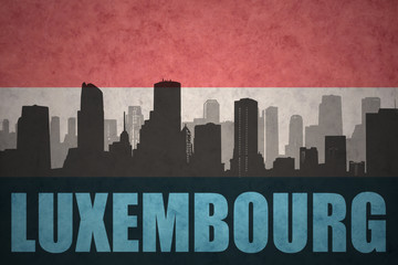 abstract silhouette of the city with text luxembourg at the vintage luxembourg flag
