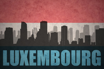 Fototapeta premium abstract silhouette of the city with text luxembourg at the vintage luxembourg flag