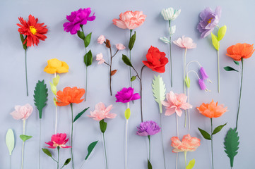 Colourful handmade paper flowers on light blue background