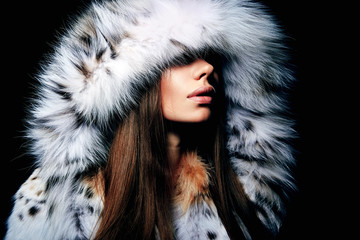 Luxury girl with long brown hair in a fur coat. The Snow Queen. Cold girl.