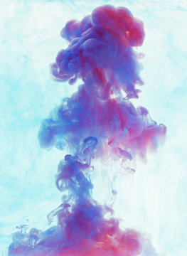 Color drop underwater creating a silk drapery. Ink swirling unde