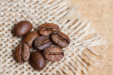 Grains of coffee plant on sackcloth, burlap texture. Coffee motif wallpaper