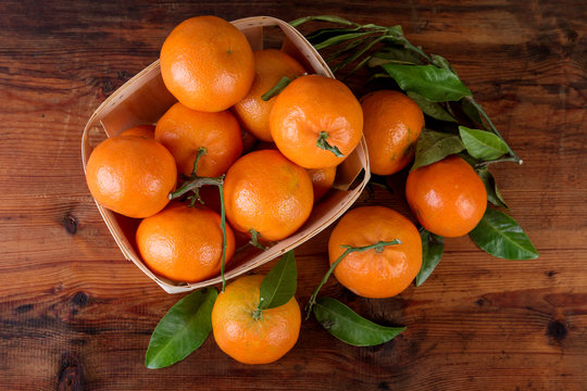 Mandarins tangerines on wooden table top view