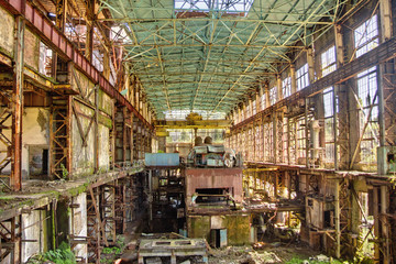Fototapeta premium Abandoned, destroyed by war and overgrown machinery of Tkvarcheli power plant 