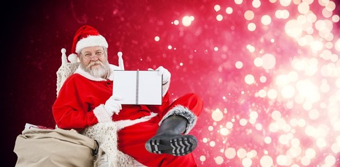 Composite image of santa claus showing diary