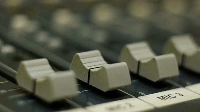 Professional audio mixing console with faders and adjusting knobs - radio