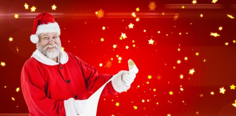 Composite image of portrait of santa claus smiling and holding s