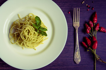 Italian pasta spaghetti with homemade pesto sauce and basil leaf