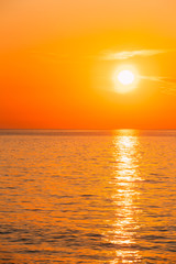 Fototapeta na wymiar Sun Is Setting On Horizon At Sunset Sunrise Over Sea Or Ocean. T