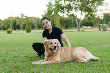 Girl playing with dog on grass