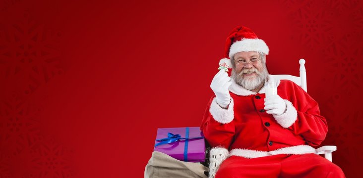 Composite image of portrait of santa claus holding milk and cook