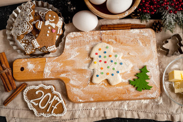 cooking christmas gingerbread on wooden background top view