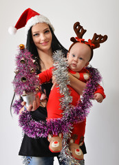 young mother with the baby celebrating Christmas