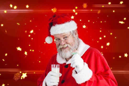 Composite image of cheerful santa claus showing glass