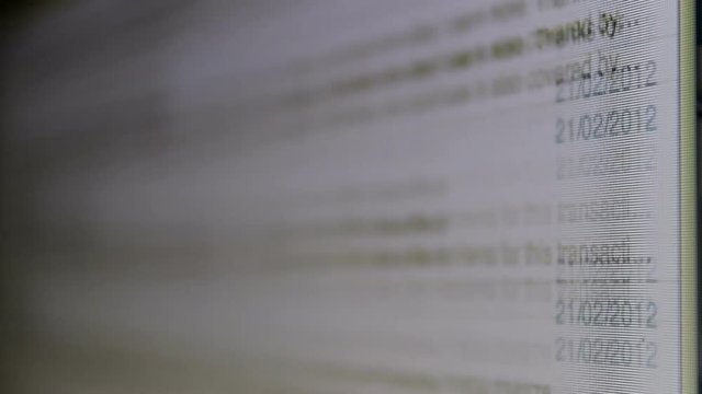 Macro shot of a computer screen showing the user browsing through a huge list of unread emails.
