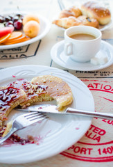 Breakfast including pancakes with raspberry jam