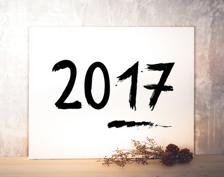 Happy new year 2017 on white poster over cement wall background
