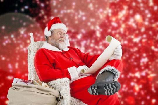 Composite image of santa claus smiling and reading