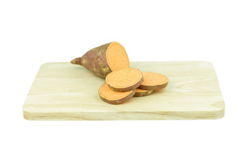 Sweet potato on wooden cutting board isolated on white