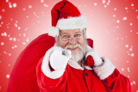 Composite image of close-up portrait of santa claus pointing