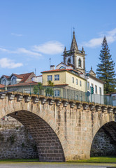 Roman bridge in front of a church in Ponte da Barca