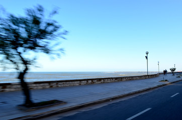 View of the ocean from car in movement