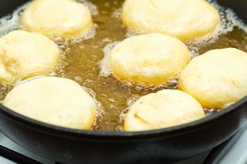 Donuts frying in deep fat
