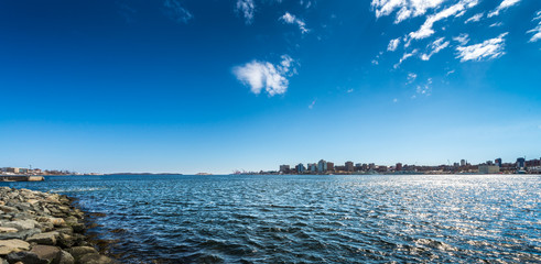 Halifax, Nova Scotia seen across Halifax Harbour from Dartmouth under a deep blue sky - obrazy, fototapety, plakaty