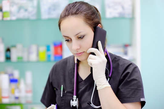 Female surgeon using cell phone