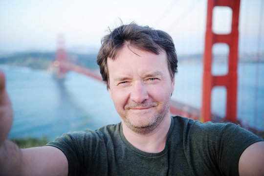 Man making a selfie with famous Golden Gate bridge