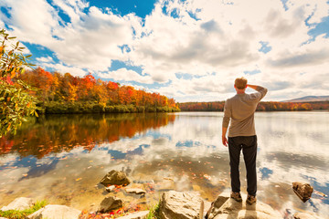 Man standing at he edge of a lake