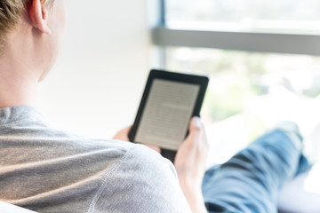 Man reading a book on digital device