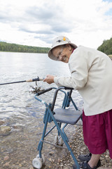 elderly woman with a fishing pole