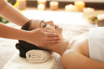 Obraz na płótnie Canvas Spa concept. Young woman enjoying of facial massage in spa salon