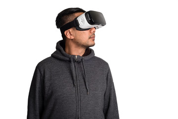 young asian man wearing virtual reality goggles looking upwards