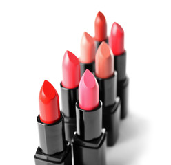 Assortment of lipsticks on white background