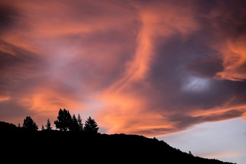 Ridgeline silhouetted against fiery sky