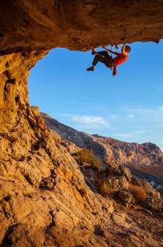 Male climber on overhanging cliff