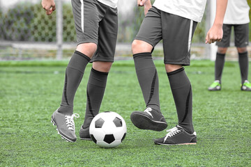 Boys playing football at stadium