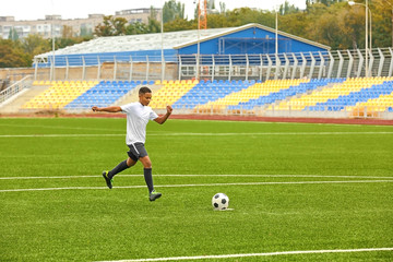 Boy playing football at stadium